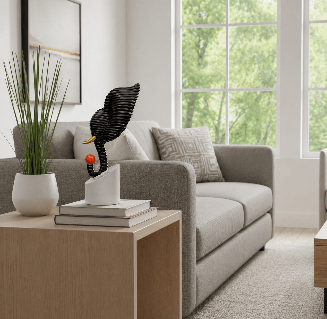 Abstract black textured elephant head sculpture holding a red ball, displayed on a modern living room side table over decorative books preview 4